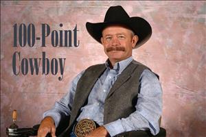 Leslie smiling in cowboy hat, mustache and vest, seated in a custom wheelchair beside the caption "100-Point Cowboy"