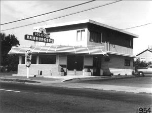 A two story building with a diner sign in front