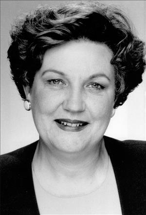 Head and shoulders portrait of a woman with short hair. 