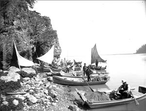 Fishermen sitting in sailboats and rowboats waiting to gillnet in the Skagit River