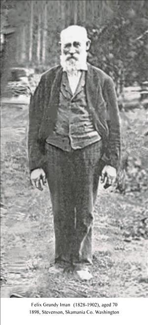 Black and white photo of old man with white beard and mustache standing a clearing 