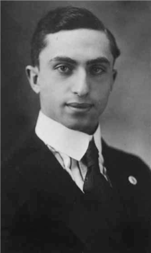  Head and shoulders portrait of a young man in a suit and tie. 