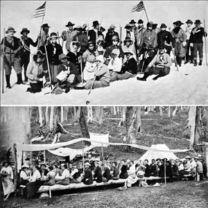 Two images. The top image shows a large group of people in winter clothing, sunglasses, and hats posing together in the snow with two American flags flying behind them. The lower image shows a large group of people sitting around a long table in the forest. 