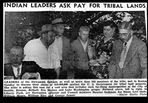 A newspaper clipping depicts six people who appear to be indigenous standing in a semi-circle in a forested area. The headline says indian leaders ask pay for tribal lands. 