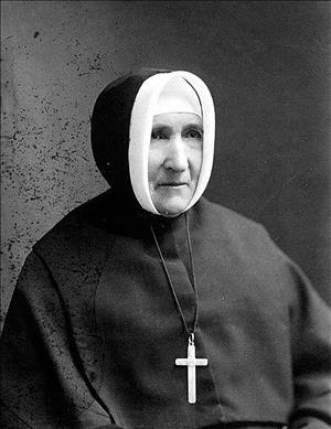 A woman in a nun's habit with a cross around her neck