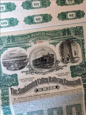 Green and black document showing an old train car, a large tree, and an small town above the words The Snohomish Valley Railway Company Total Issue $250,000