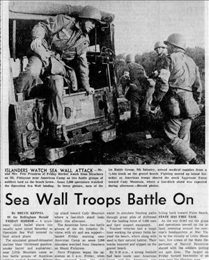 Men in military uniform climb from the back of a jeep in a newspaper headline