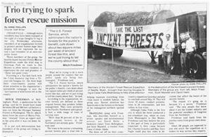 Three men stand next to a large log on a truck bed next to a headline that says Trio Trying to Spark Forest Rescue Mission. The log has a banner hanging on it that says Save the Last Ancient Forests