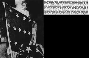 Newspaper clipping shows a woman holding a large flag next to text explaining that it is the Jackson flag and is kept at the Washington State Historical Society Museum. 