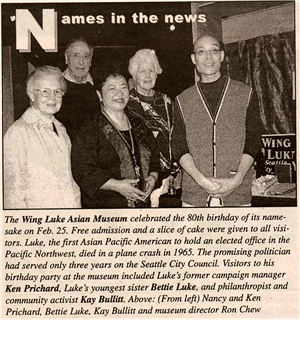 A newspaper clipping with the headline Names in the News. Five people, some white some asian, pose for a photo. the article is about Wing Luke Museum celebrating its 80th birthday. The people in  the photo are Kay Bullitt, Bettie Luke, Nancy and Ken Pritchard, and Ron Chew.