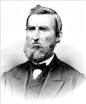 Seated portrait of Hanford wearing a suit and vest with chin beard