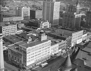 Birds eye view of downtown Tacoma, taken in May of 1939. In the lower left corner is the intersection of 9th and Broadway. The Roxy Theatre, at 901 Broadway (now known as the Pantages), is at the lower left and across Broadway is the distinctive turret of John Hamrick's Music Box Theatre