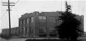 A two story brick building with large windows. 