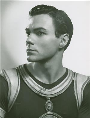 A head and shoulder profile portrait of a man in a dance costume. 