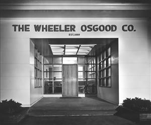 Midcentury entryway with the words The Wheeler Osgood Co Established 1889 painted above. 