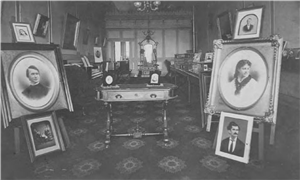 A parlor with framed portraits of different sizes on display