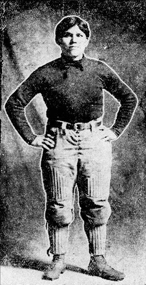 Person in padded football uniform posing with hands on hips